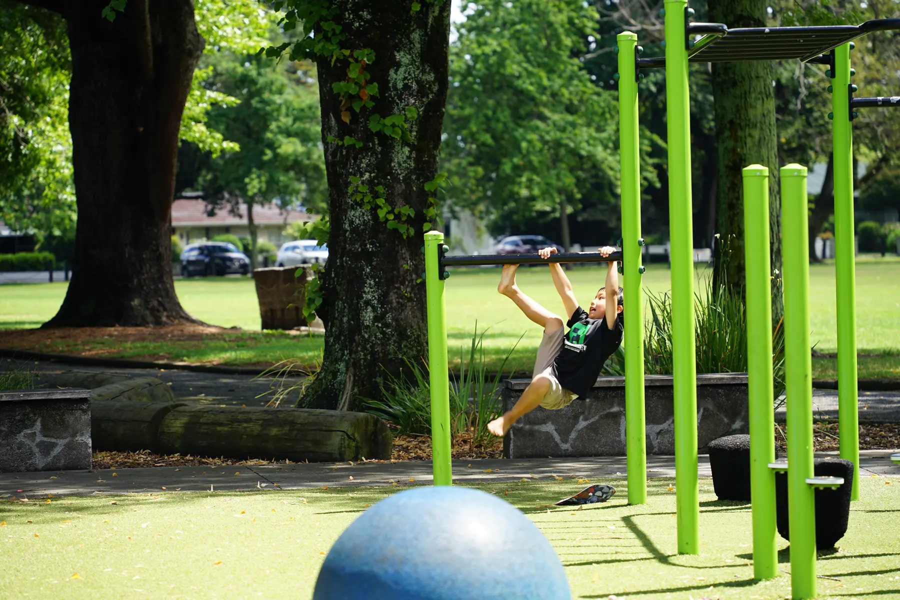 A child swinging in a green city park